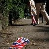 A British flag which was washed away by heavy rains the day before lies on the street in London (Photo: Reuters)