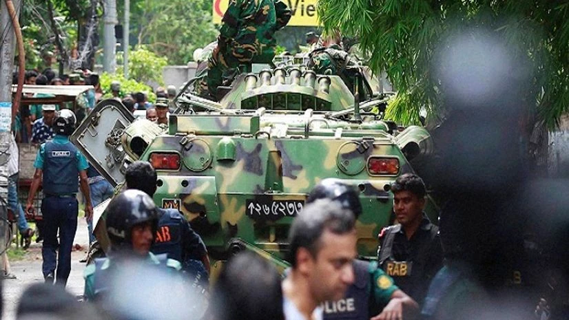 Bangladeshi soldiers and security personnel sit on top of armored vehicles as they cordon off an area near a restaurant popular with foreigners after heavily armed militants took dozens of hostages in a diplomatic zone of the Dhaka. Bangladeshi soldiers and security personnel sit on top of armored vehicles as they cordon off an area near a restaurant popular with foreigners after heavily armed militants took dozens of hostages in a diplomatic zone of the Dhaka.