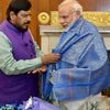 Prime Minister Narendra Modi is presented a shawl by newly inducted minister Ramdas Athavale at a meeting in New Delhi