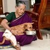 A woman feeding the dog which was rescued after being thrown from a four storey building by two MBBS students last week, at her home in Chennai