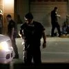 Dallas police detain a driver after several police officers were shot in downtown Dallas. Snipers apparently shot police officers during protests and some of the officers are dead, the city's police chief said in a statement.