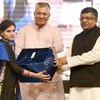 Union IT Minister Ravi Shankar Prasad and MOS P P Choudhary honours a villege level entrepreneur at the launch of a service "Adhaar as a catalyst for Financial Inclusion" in New Delhi
