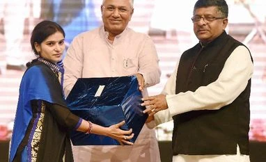 Prasad blasts Cong on scam allegation Union IT Minister Ravi Shankar Prasad and MOS P P Choudhary honours a villege level entrepreneur at the launch of a service "Adhaar as a catalyst for Financial Inclusion" in New Delhi