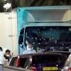 Forensic officers stands near a truck with its windscreen riddled with bullets that plowed through a crowd of revelers who'd gathered to watch the fireworks in the French resort city of Nice, southern France.