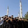 Turkish policemen salute as they attend a mass funeral for their comrades who were killed Friday during the failed military coup, in Ankara, Turkey