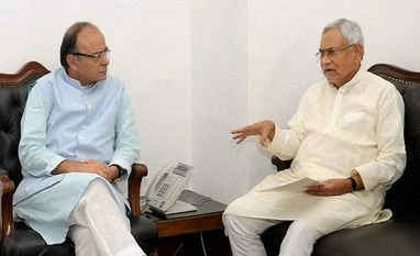 To isolate Congress on GST, govt plans to reach out to parties Union Minister for Finance and Corporate Affairs, Arun Jaitley with Chief Minister of Bihar, Nitish Kumar at a meeting in New Delhi.
