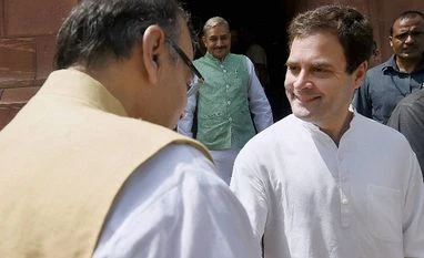 Govt optimistic on GST passage Congress Vice President Rahul Gandhi shakes hand with Union Finance Minister Arun Jaitley at Parliament house during the monsoon session in New Delhi