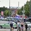 Police cars stand outside the Olympia shopping centre after a shooting was reported there in Munich, southern Germany