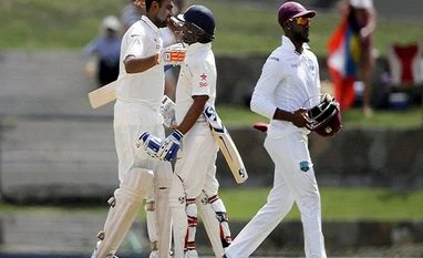Batting promotion boosted my confidence, says buoyant Ashwin India's Ravichandran Ashwin, left, is embraced by teammate Amit Mishra after scoring a century as West Indie's Jermaine Blackwood walks during day two of their 1st cricket Test match at the Sir Vivian Richards Stadium in North Sound, Antigua.