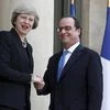 Francois Hollande greets Theresa May