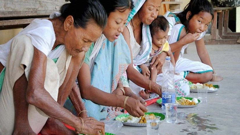 Villagers eating at a relief camp after their homes were submerged due to floods at Bhakat Gaon in Morigaon district of Assam on Saturday Photo: PTI Villagers eating at a relief camp after their homes were submerged due to floods at Bhakat Gaon in Morigaon district of Assam on Saturday Photo: PTI