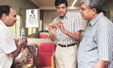Drishti: Affordable eye care for the underserved Drishti founder and CEO Kiran Anandampillai (centre) and Nandan Nilekani (right) with a patient inside their mobile van