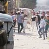 A file photo of protesters pelting stones at security personnel in Srinagar