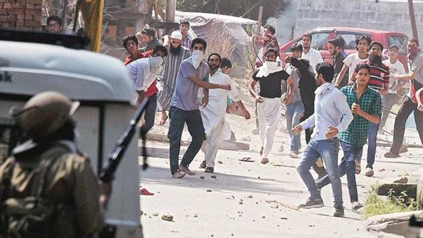 A file photo of protesters pelting stones at security personnel in Srinagar A file photo of protesters pelting stones at security personnel in Srinagar