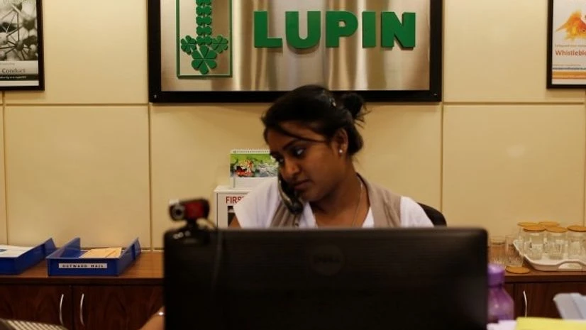 An employee of Lupin Limited works at a reception at their headquarters in Mumbai An employee of Lupin Limited works at a reception at their headquarters in Mumbai