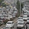 Heavy traffic moves along a busy road during a power-cut at the traffic light junctions in New Delhi