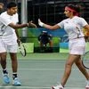 Sania Mirza and Rohan Bopanna exchange hifi during their match against S Stosur and J Peers of Australia during the 2016 Summer Olympics at Rio de Janeiro in Brazil.