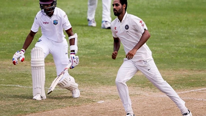 India's Bhuvneshwar Kumar, right, bowls next to West Indies' batsman Shane Dorwich during day four of their 3rd cricket Test match at the Daren Sammy Cricket Ground in Gros Islet, St. Lucia. India's Bhuvneshwar Kumar, right, bowls next to West Indies' batsman Shane Dorwich during day four of their 3rd cricket Test match at the Daren Sammy Cricket Ground in Gros Islet, St. Lucia.