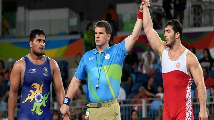 Ildem Cenk of Turkey is declared winner against India's Hardeep Singh (Blue) in Men's 98 Kg wrestling Ildem Cenk of Turkey is declared winner against India's Hardeep Singh (Blue) in Men's 98 Kg wrestling