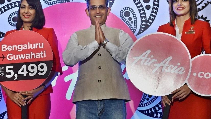 Air Asia India CEO Amar Abrol with Airlines hostesses during a press conference to announce the fleet and route expansion plans in Bengaluru Air Asia India CEO Amar Abrol with Airlines hostesses during a press conference to announce the fleet and route expansion plans in Bengaluru