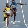 Elaine Thompson from Jamaica, left wins the gold medal in the women's 200-meter final ahead of third placed United States' Tori Bowie