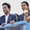 Olympic Silver Medalist P V Sindhu with her Coach Pullela Gopichand flaunts her medal after her arrival at Rajiv Gandhi International Airport in Hyderabad.