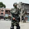 A security person stands guard in a street during the 45th day of curfew in Srinagar