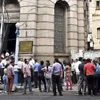 People vacate their offices and stand outside after the alerts of earthquake, in Kolkata