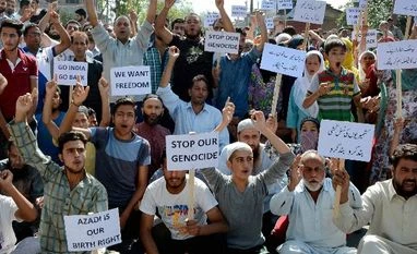 Barring Srinagar, curfew lifted across Kashmir People hold placards and shout slogans during protest against the killing of civilians by security force in Srinagar