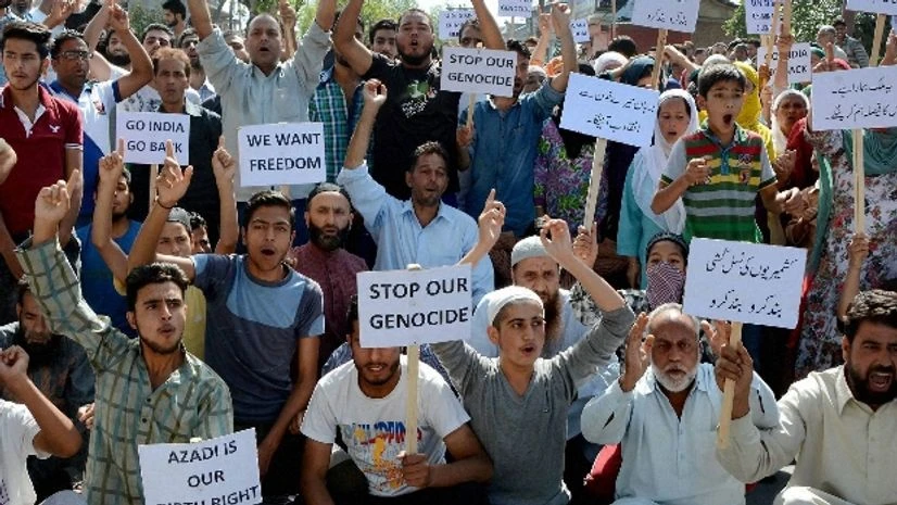 People hold placards and shout slogans during protest against the killing of civilians by security force in Srinagar People hold placards and shout slogans during protest against the killing of civilians by security force in Srinagar