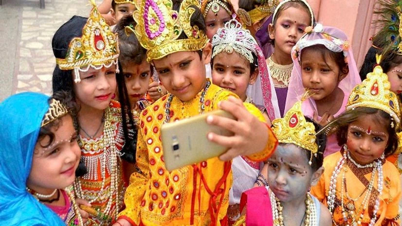 Children dressed as Lord Krishna and Radha click selfie ahead of Janamashtami festival in Ajmer, Rajasthan Children dressed as Lord Krishna and Radha click selfie ahead of Janamashtami festival in Ajmer, Rajasthan