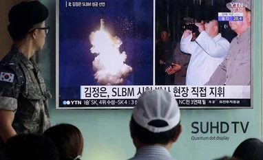 North Korea tests new rocket engine: Media A South Korean army soldier watches a TV program showing images of North Korea's ballistic missile believed to have been launched from underwater and North Korean leader Kim Jong-un, at Seoul Railway Station. Photo: AP | PTI