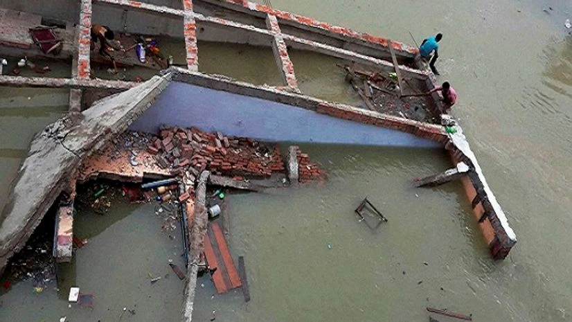 A building collapses in flood water at Chapra in Saran district of Bihar. A building collapses in flood water at Chapra in Saran district of Bihar.