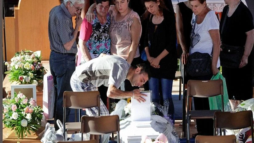 Relatives mourn over a coffin of one of the earthquake victims prior to the start of the funeral service in Ascoli Piceno, Italy. Relatives mourn over a coffin of one of the earthquake victims prior to the start of the funeral service in Ascoli Piceno, Italy.