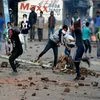 Protesters throwing stones on security forces during a clash in Srinagar