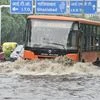ehicle pass through water logged roads after rain in  New Delhi