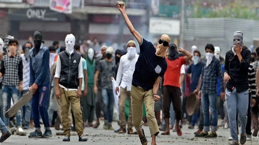 Protesters throwing stones at police during a clash which erupted after police stopped them to march towards Lal Chowk, in Srinagar Protesters throwing stones at police during a clash which erupted after police stopped them to march towards Lal Chowk, in Srinagar