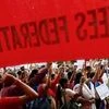 Workers from various trade unions shout slogans during an anti-government protest rally, organised as part of a nationwide strike, in Mumbai