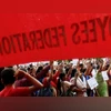 Workers from various trade unions shout slogans during an anti-government protest rally, organised as part of a nationwide strike, in Mumbai