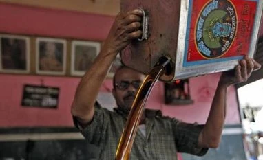 Govt soon to make GM mustard stance public, develop more varieties A worker fills a container with mustard oil