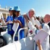 A Missionaries of Charity nun greets Pope Francis upon his arrival in St. Peter's Square at the Vatican for a jubilee audience for workers and volunteers of mercy.