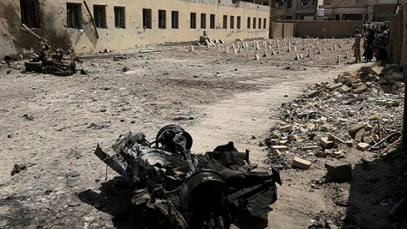 Remains of car bombs litter a school yard used as a cemetery for deceased Islamic State group fighters in Fallujah, 40 miles (65 km) west of Baghdad, Iraq. Remains of car bombs litter a school yard used as a cemetery for deceased Islamic State group fighters in Fallujah, 40 miles (65 km) west of Baghdad, Iraq.