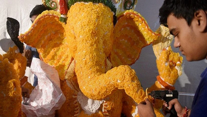 Not a happy festivals season Artists decorate a Ganesha Idol with Jalebis (Indian sweet) ahead of Ganesh festival in Mumbai