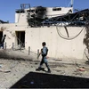Afghan security forces work at a suicide attack site in Kabul, Afghanistan