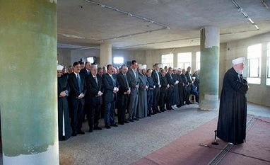 China calls for political solution to Syrian crisis In this photo released on the official Facebook page of the Syrian Presidency, Syrian President Bashar al-Assad, 6th left, prays the dawn Eid al-Adha prayers at the Saad ibn Muaaz Mosque in Daraya, a blockaded Damascus suburb, Syria. Photo: AP/PTI