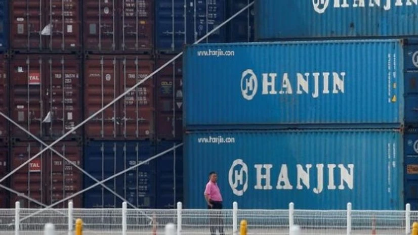A man stands in front of shipping containers at the Hanjin Shipping container terminal at Incheon New Port in Incheon, South Korea A man stands in front of shipping containers at the Hanjin Shipping container terminal at Incheon New Port in Incheon, South Korea