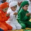 Children dressed in colors of Indian national flag offer namaz on the occasion of Eid al-Adha in Mathura