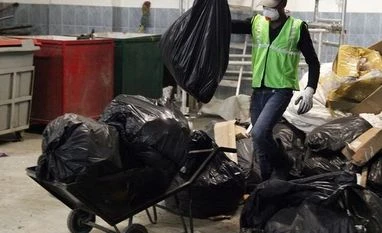 Businesses designed to help poor in India attracting overseas investors: Poll Workers from an environmentally-friendly rubbish disposal business called ScrapApp sort through garbage in a shopping mall in Noida