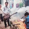 A Municipal Corporation of Delhi (MCD) worker fumigates an area to prevent mosquitos from breeding, in New Delhi on Saturday | Photo: PTI