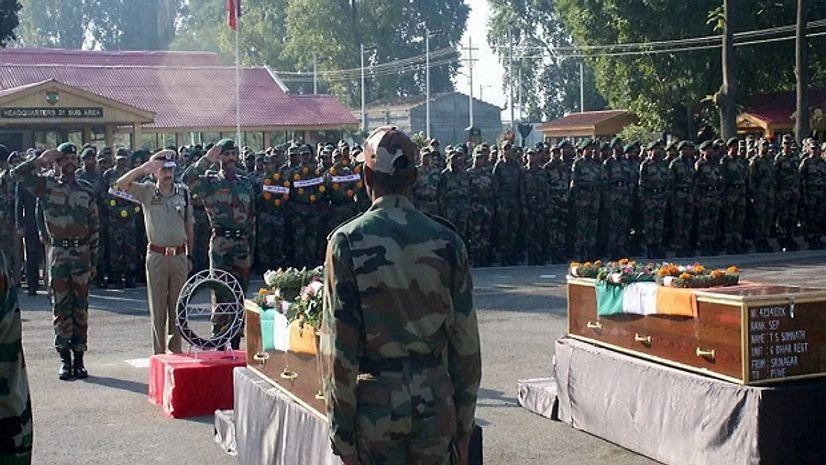 A senior Police officer paying tribute to the soldiers killed in Uri attack, at a ceremony in Srinagar. Photo:PTI A senior Police officer paying tribute to the soldiers killed in Uri attack, at a ceremony in Srinagar. Photo:PTI